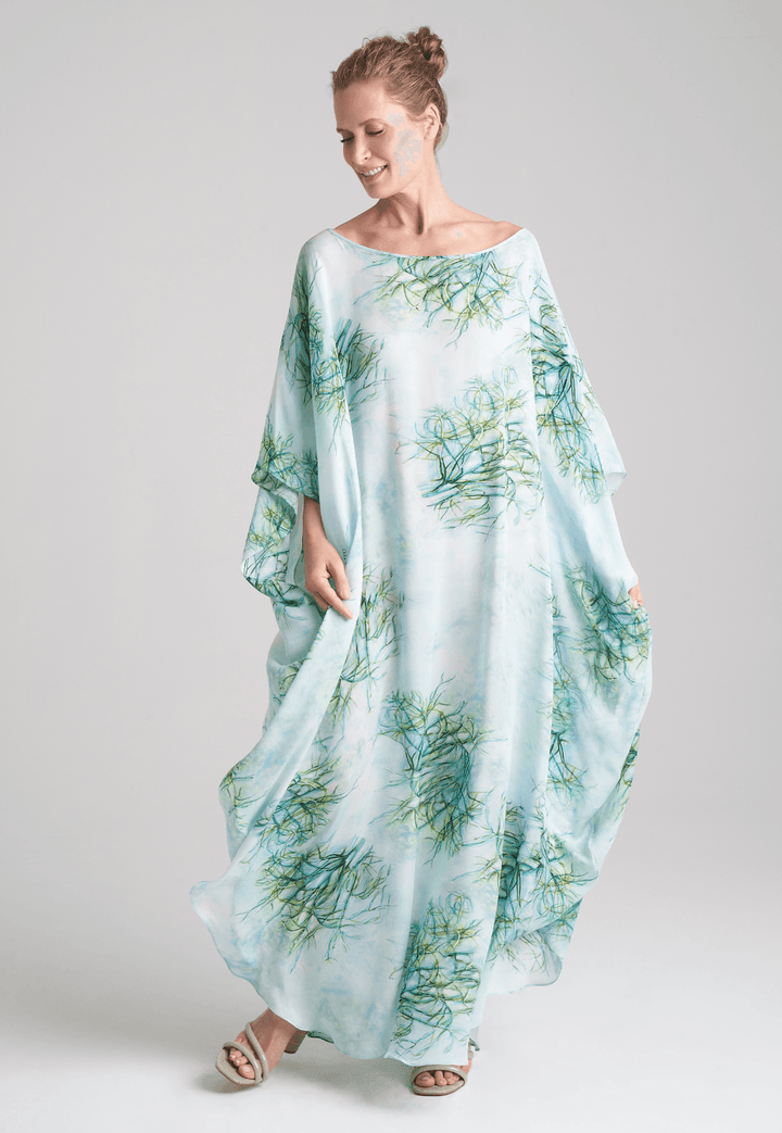 Woman wearing silk boat neck green printed kaftan by Ala von Auersperg