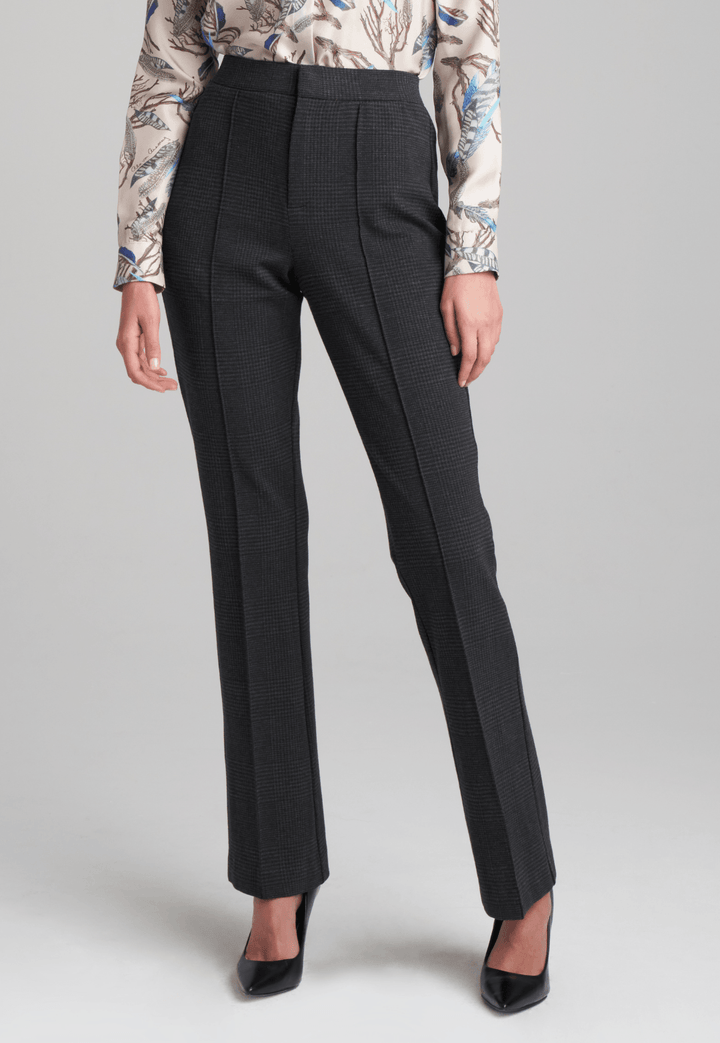 Woman wearing printed silk feather blouse with stretch knit plaid pants by Ala von Auersperg for fall 2022