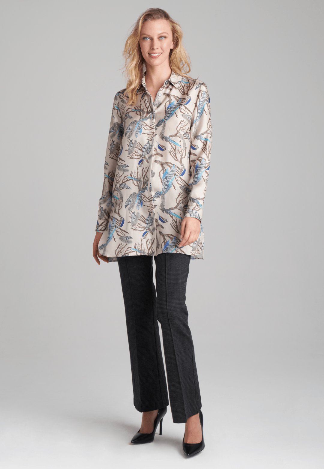 Woman wearing silk feather printed blouse and plaid stretch knit pants by Ala von Auersperg for fall 2022