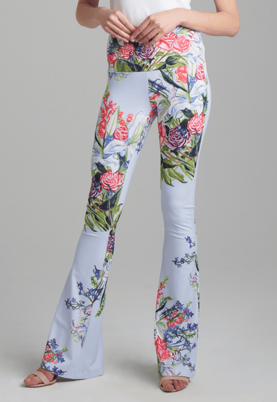 Woman wearing stretch knit floral bouquet printed flair pants with italian stretch cotton square neck tank top by Ala von Auersperg for spring summer 2022