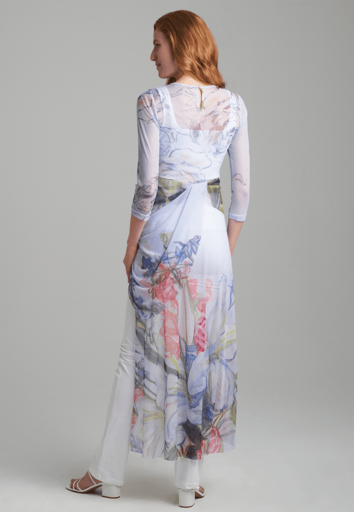 Woman wearing sheer mesh asymmetrical  floral bouquet printed topper over italian stretch cotton square neck tank and pants by Ala von Auersperg for spring summer 2022