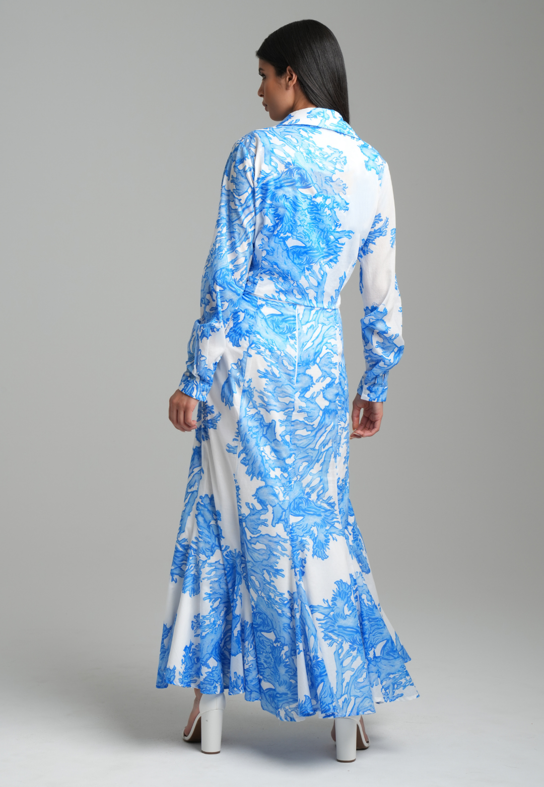 Woman wearing blue coral printed cotton voile long skirt with blue coral printed square neck stretch knit tank top and blue coral printed cotton wrap top by Ala von Auersperg for resort 2023