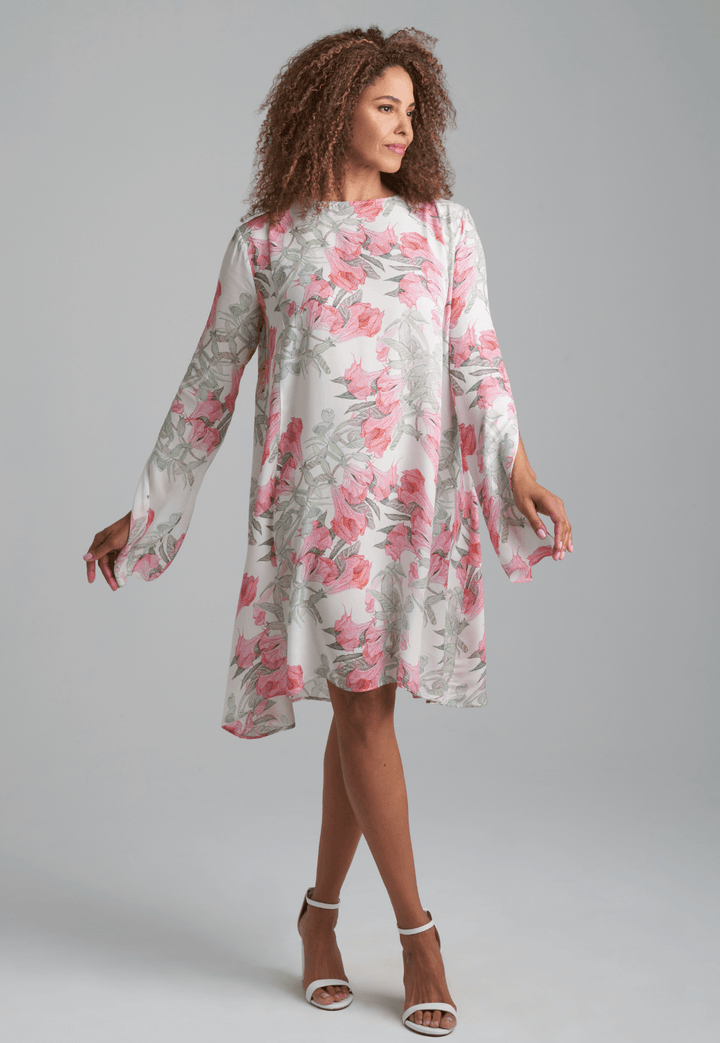 Woman wearing short flower printed silk cocktail dress with long sleeves by Ala von Auersperg for spring summer 2022