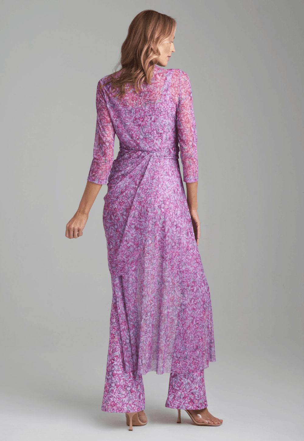 Woman wearing mesh topper in printed pink orchid flowers over stretch knit printed pink orchid flowers over tank top and pants by Ala von Auersperg for resort 2022