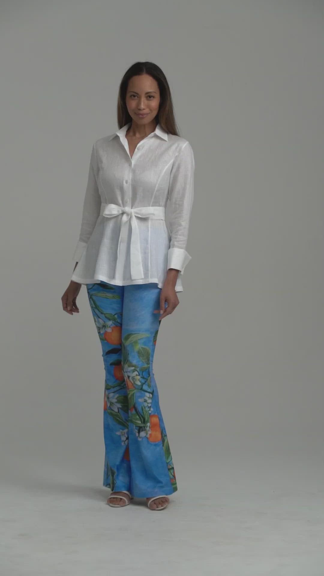 Model wearing white linen blouse with printed stretch knit pants