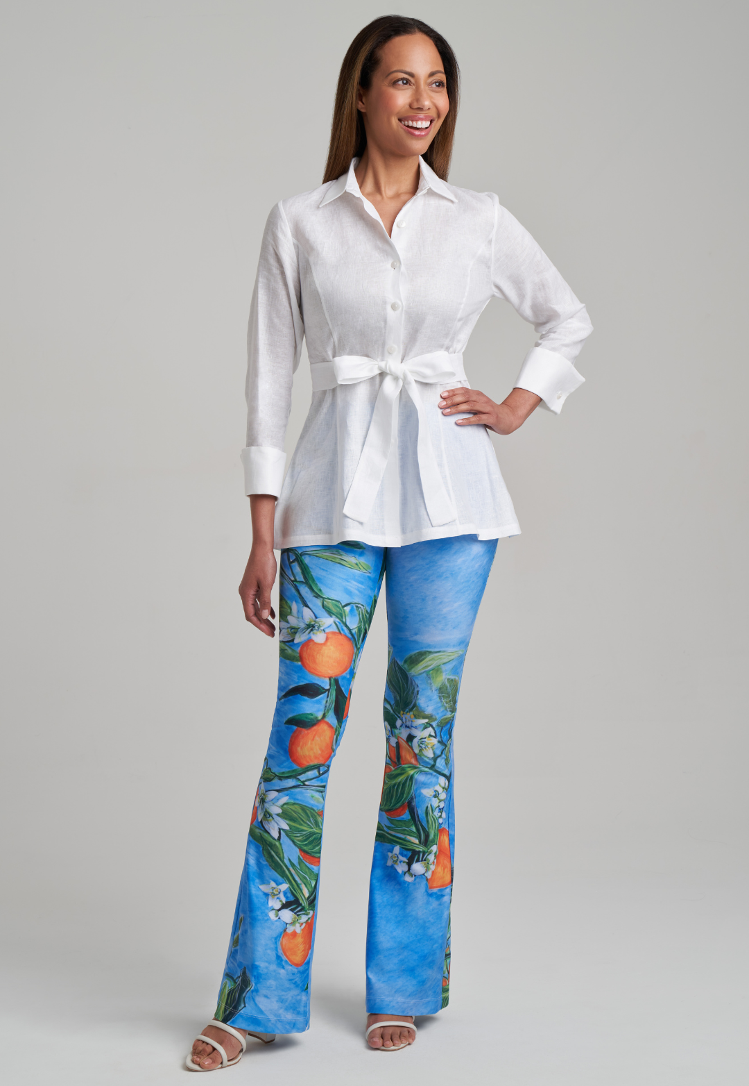 Model wearing white linen blouse with printed stretch knit pants
