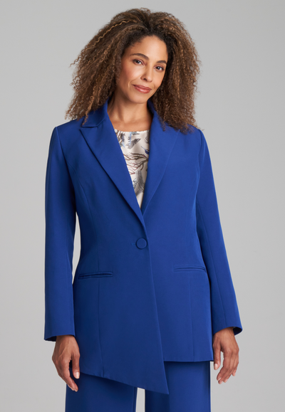 Woman wearing silk lined sapphire blazer with printed silk shell tank top and stretch blue pants suite by Ala von Auersperg for fall 2022