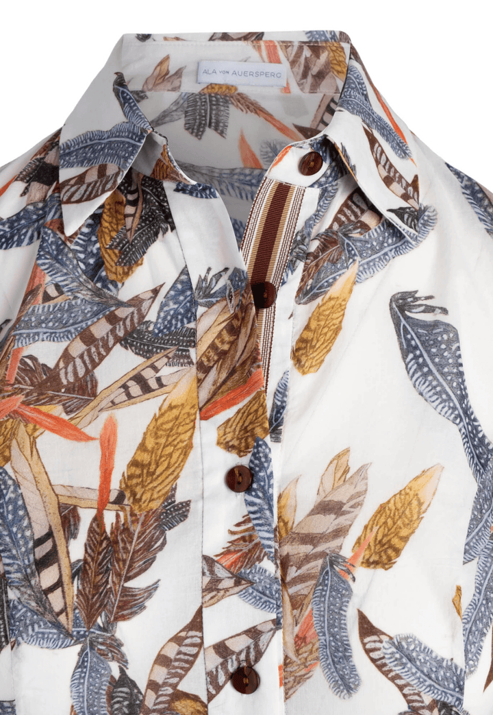 Detail shot of collar and ribbon detail on the feather printed cotton shirtdress by Ala von Auersperg