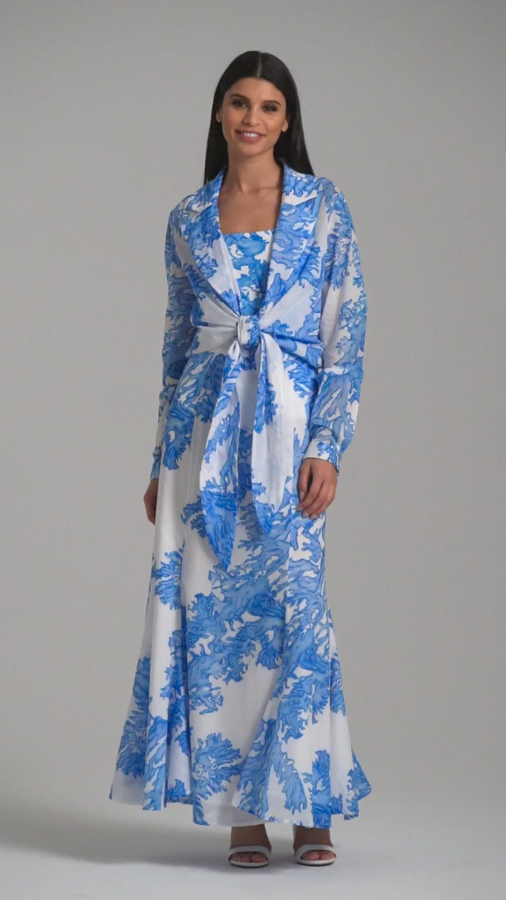 Woman wearing blue coral printed cotton voile long skirt with blue coral printed square neck stretch knit tank top and blue coral printed cotton wrap top by Ala von Auersperg for resort 2023