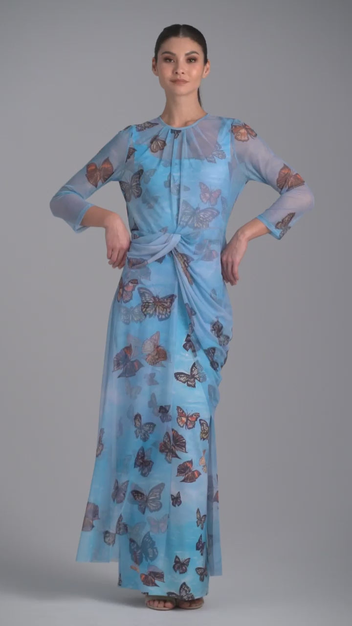 Woman wearing blue butterfly printed mesh topper over blue butterfly printed stretch knit tank top and pants by Ala von Auersperg for spring 2023
