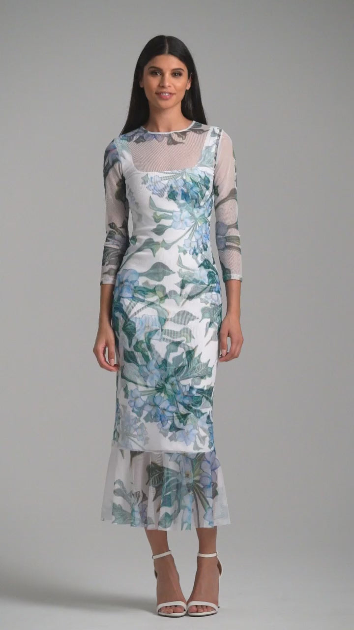 Woman wearing green mock coffee printed mesh dress with ruffle bottom over stretch knit mock coffee square necks short dress by Ala von Auersperg for resort 2023