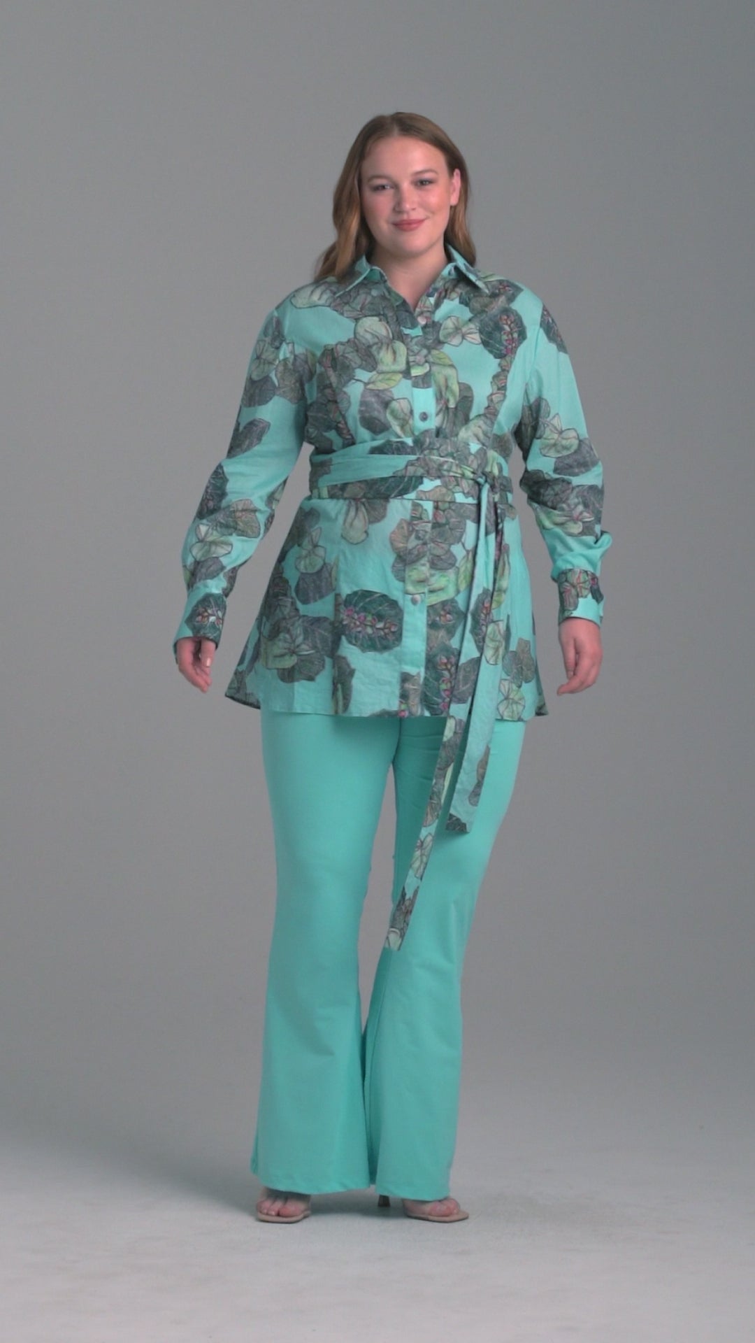 Woman wearing grape leaf cotton blouse with stretch knit blue pants by Ala von Auersperg for resort 2022