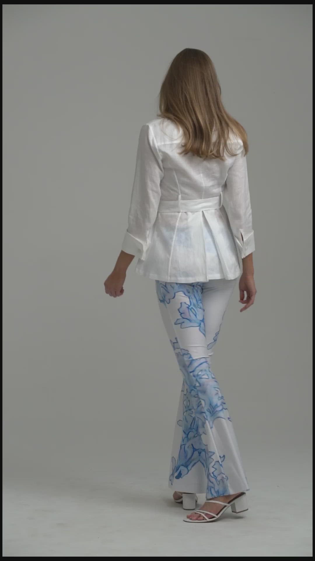 Model wearing white linen blouse with printed stretch knit pants
