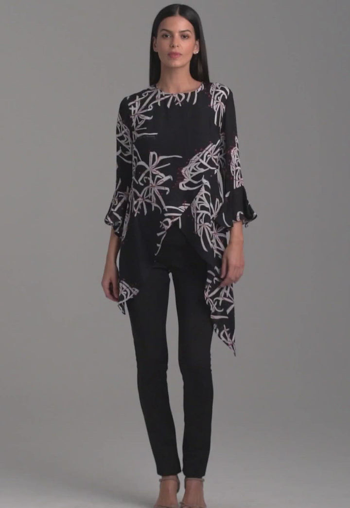 Woman wearing assymetrical black spider lily silk blouse by Ala von Auersperg for holiday 2021